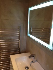 Sink, heated towel rail and lighted mirror