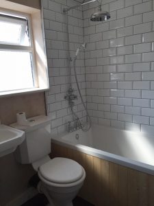 Sink, toilet, bath, shower installation with metro tiling